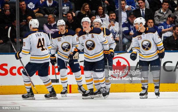 Jack Eichel of the Buffalo Sabres celebrates his goal with teammates Justin Falk, Nathan Beaulieu, Zemgus Girgensons, and Jason Pominville against...