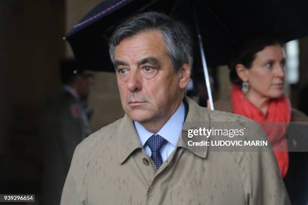Former French Prime Minister Francois Fillon leaves after a national ceremony for Lieutenant-Colonel Arnaud Beltrame, on March 28, 2018 at the Hotel...