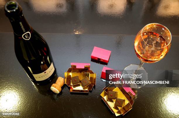 Picture taken on March 22, 2018 in Reims shows a bottle of rose Champagne of Castelnau and chocolates with Espelette pepper made by master...