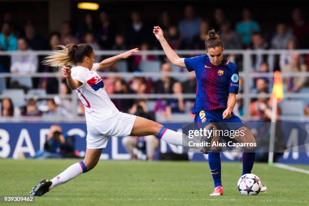 Melanie Serrano of FC Barcelona plays the ball under pressure from Delphine Cascarino of Olympique Lyon during the UEFA Women's Champions League...