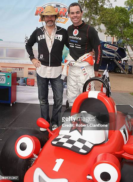 Television presenter Paul McDermott poses with Team Vodafone V8 driver Craig Lowndes at the Roary VIP Pit Party prior to qualifying for race 25 of...