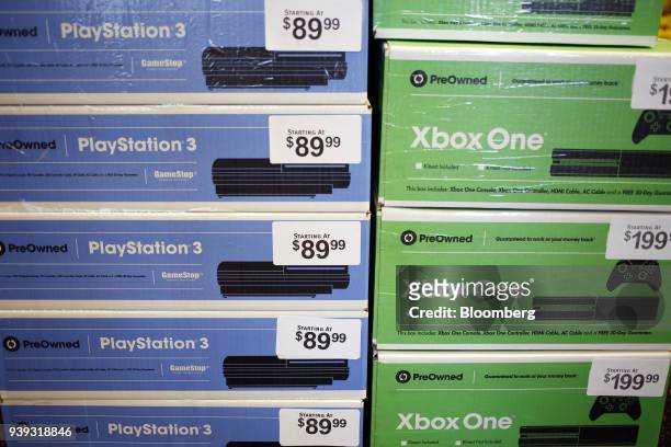 Pre-owned Sony Corp. PlayStation 3 and Microsoft Corp. Xbox One game consoles are displayed for sale inside a GameStop Corp. Store in Louisville,...