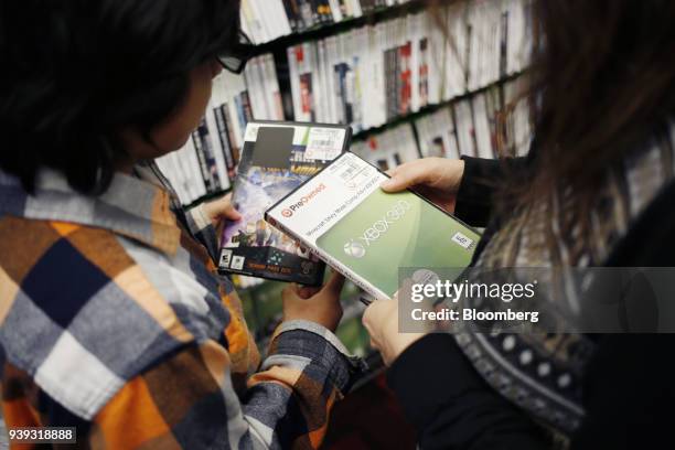 Customers shop for pre-owned Microsoft Corp. Xbox 360 Minecraft video games inside a GameStop Corp. Store in Louisville, Kentucky, U.S., on Thursday,...