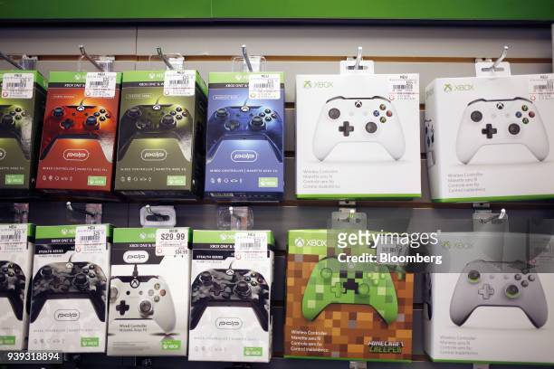 Microsoft Corp. Xbox One video game controllers are displayed for sale inside a GameStop Corp. Store in Louisville, Kentucky, U.S., on Thursday,...