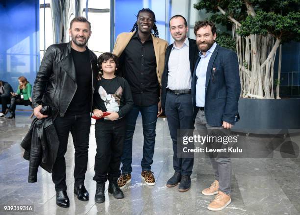 Okan Buruk with his son, Bafetimbi Gomis and guests attends the St. Nian show during Mercedes Benz Fashion Week Istanbul at Zorlu Performance Hall on...