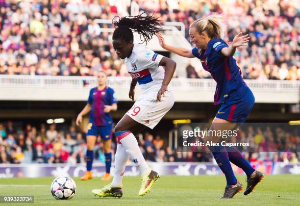 Griedge M'Bock Bathy of Olympique Lyon controls the ball under pressure from Toni Duggan of FC Barcelona during the UEFA Women's Champions League...