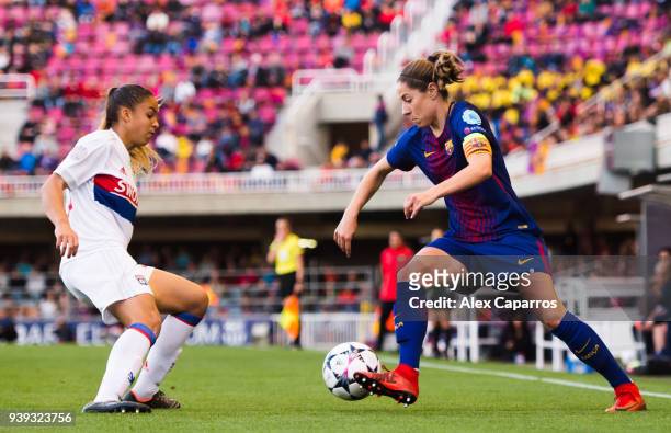 Vicky Losada of FC Barcelona conducts the ball under pressure from Delphine Cascarino of Olympique Lyon during the UEFA Women's Champions League...