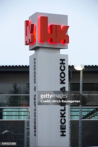 Exterior view of the headquarters of the weapons manufacturer Heckler & Koch in Oberndorf - iluminated logo.