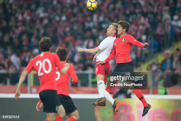 Kamil Glik of Poland vies Jeong-ho Hong , during the international friendly soccer match between Poland and South Korea national football teams, at...