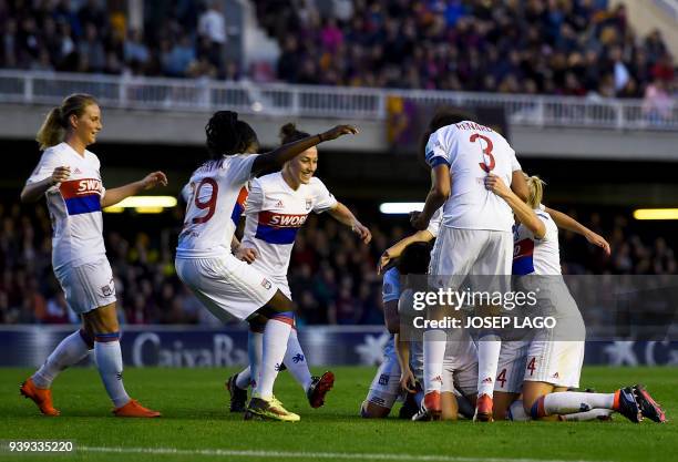 Lyon players celebrate their opening goal during the UEFA Women's Champions League quarter-final second leg football match between FC Barcelona and...