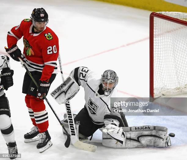 Jonathan Quick of the Los Angeles Kings makes a kick save behind Brandon Saad of the Chicago Blackhawks at the United Center on February 19, 2018 in...