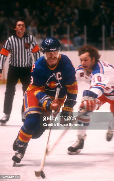 Lanny McDonald of the Colorado Rockies skates with the puck as Ron Duguay of the New York Rangers defends during an NHL game on March 11, 1981 at the...