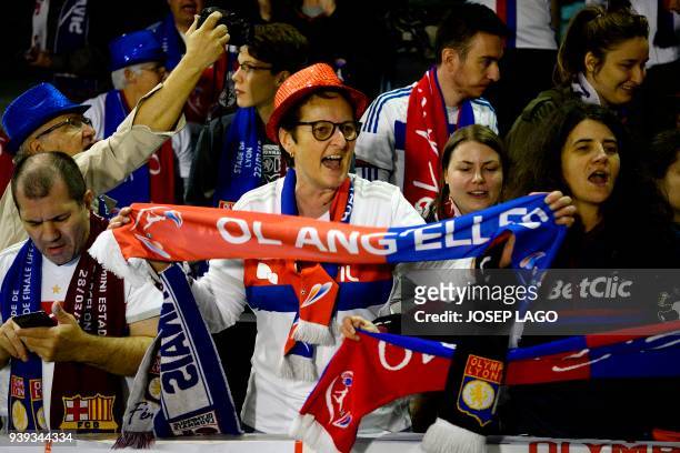 Lyon fans celebrate their team's victory at the end of the UEFA Women's Champions League quarter-final second leg football match between FC Barcelona...