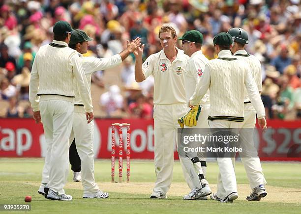 Nathan Hauritz of Australia celebrates with his teammates after taking the wicket of Sulieman Benn during day two of the Second Test match between...