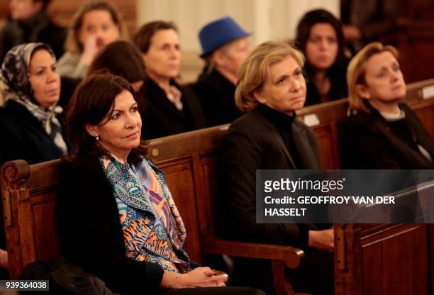 Mayor of Paris Anne Hidalgo sits with others in The Synagogue des Tournelles in Paris on March 28 during a service in memory of Mireille Knoll, the...
