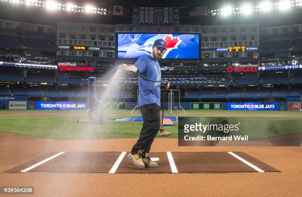 Jeff Klesc and Kevin MacBride , with field operations, hose down home plate area at Rogers Centre, Toronto, prior to tomorrow's Toronto Blue Jays...