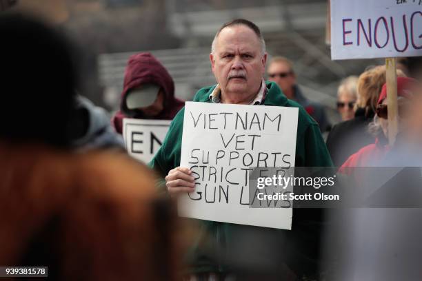 People join a rally to show support for students who finished the last leg of a 50-mile journey in the hometown of House Speaker Paul Ryan to call...