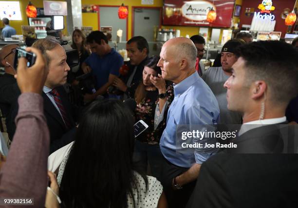 Florida Governor Rick Scott speaks to the media at Restaurant El Arepazo 2 after holding a bill signing ceremony for legislation to prohibit all...