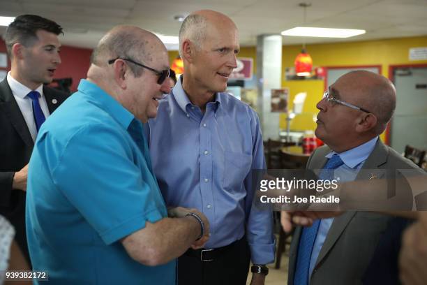 Florida Governor Rick Scott interacts with people at Restaurant El Arepazo 2 as he holds a bill signing ceremony for legislation to prohibit all...