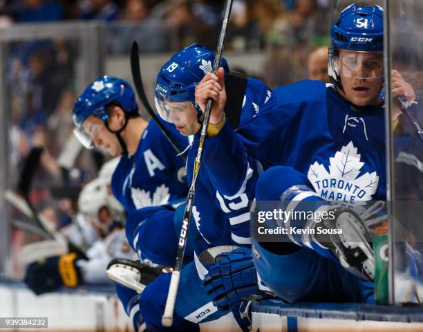 Tyler Bozak of the Toronto Maple Leafs, Tomas Plekanec of the Toronto Maple Leafs and Jake Gardiner climb over the board at an NHL game against the...