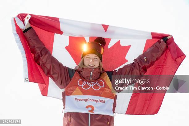 Golden sparkle on the goggles of gold medalist Cassie Sharpe of Canada as she celebrates on the podium after her win during the Freestyle Skiing -...