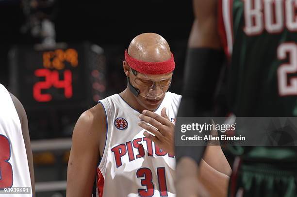 Charlie Villanueva of the Detroit Pistons adjusts his new protective mask during a game against the Milwaukee Bucks in a game at the Palace of Auburn...