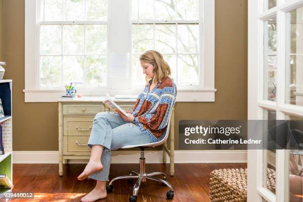 woman reading book in home office - catherine ledner 個照片及圖片檔