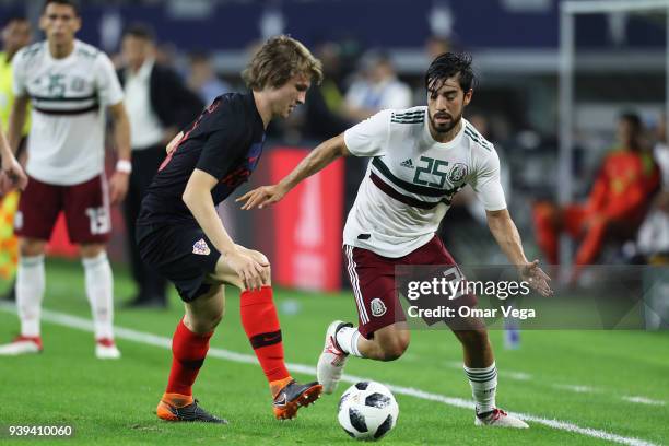 Rodolfo Pizarro of Mexico and Ante Revic of Croatia fight for the ball during the international friendly match between Mexico and Croatia at AT&T...