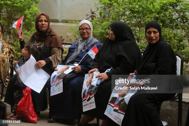 Women hold signs in support of Egyptian President Abdel Fattah al-Sisi on the last day of the 3-day the presidential elections on March 28, 2018 in...