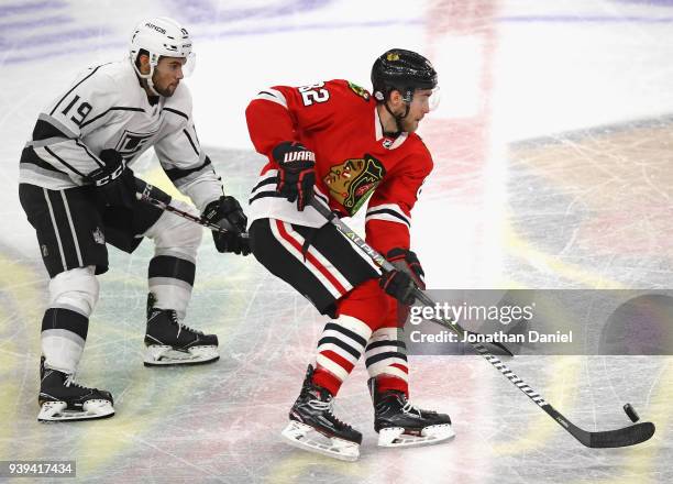 Jordan Oesterle of the Chicago Blackhawks advances the puck in front of Alex Iafallo of the Los Angeles Kings at the United Center on February 19,...