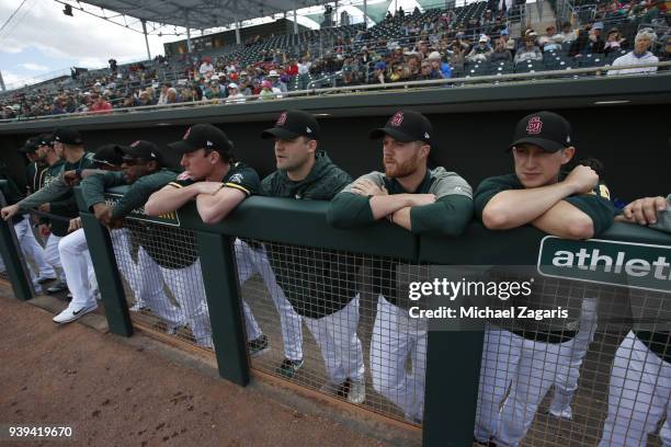 Members of the Oakland Athletics wear Marjory Stoneman Douglas High School baseball hats in honor of the shooting victims during the game against the...