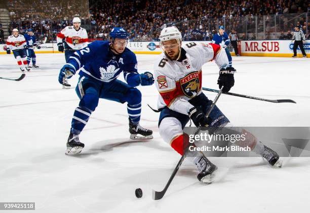 Alex Petrovic of the Florida Panthers skates against Tyler Bozak of the Toronto Maple Leafs during the first period at the Air Canada Centre on March...