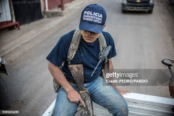 Guerrero Community Police member patrols the streets in Heliodoro Castillo, Guerrero state, Mexico, on March 24, 2018. In the mountains of Guerrero,...