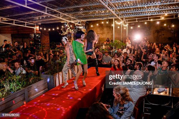 In this photograph taken on March 24 Vietnamese drag queen trio "Victeam" perform in a show at a local bar in Hanoi. A vanguard of Vietnamese drag...