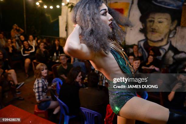 In this photograph taken on March 24 Vietnamese drag queen Vanessa performs in a show at a local bar in Hanoi. A vanguard of Vietnamese drag queens...