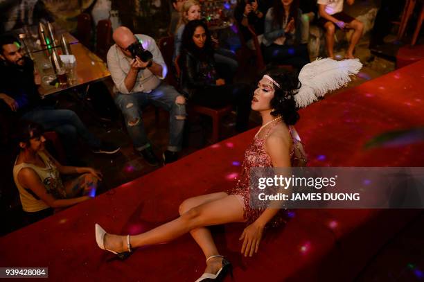 In this photograph taken on March 24 Vietnamese drag queen Za Za Zellia lip sincs a song number in her first performance at a local bar in Hanoi. A...