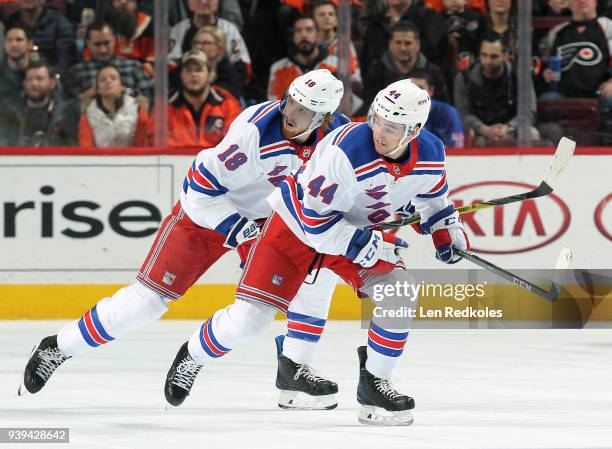 Neal Pionk and Marc Staal of the New York Rangers skate against the Philadelphia Flyers on March 22, 2018 at the Wells Fargo Center in Philadelphia,...