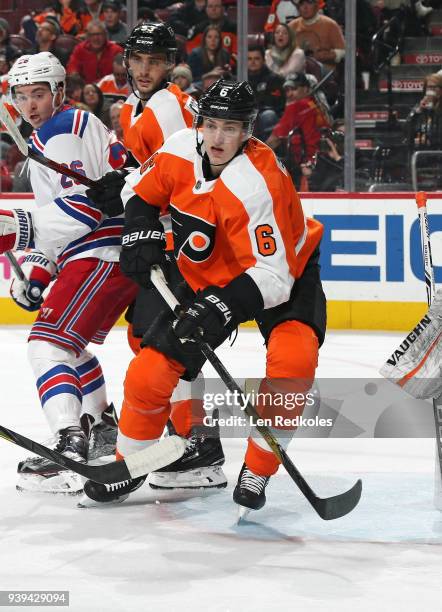 Travis Sanheim and Shayne Gostisbehere of the Philadelphia Flyers defends Jimmy Vesey of the New York Rangers on March 22, 2018 at the Wells Fargo...