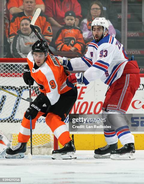 Ivan Provorov of the Philadelphia Flyers battles against Mika Zibanejad of the New York Rangers on March 22, 2018 at the Wells Fargo Center in...