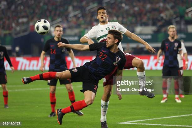 Josip Pivaric of Croatia fights for the ball with Raul Jimenez of Mexico during the international friendly match between Mexico and Croatia at AT&T...