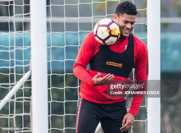 This picture taken on March 21, 2018 shows Shanghai's SIPG forward Brazilian Hulk trying to catch a ball during a training session in Shanghai. / AFP...