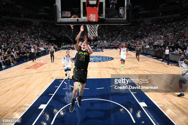 Mike Muscala of the Atlanta Hawks dunks against the Minnesota Timberwolves on March 28, 2018 at Target Center in Minneapolis, Minnesota. NOTE TO...
