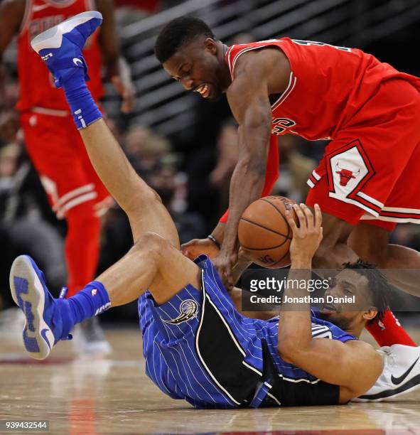 Khem Birch of the Orlando Magic tries to grab a loose ball under pressure from David Nwaba of the Chicago Bulls at the United Center on February 12,...