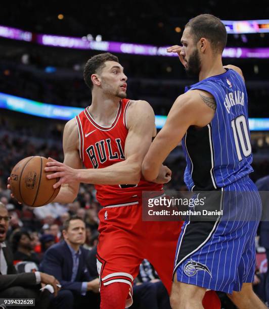 Zach LaVine of the Chicago Bulls is pressured by Evan Fournier of the Orlando Magic at the United Center on February 12, 2018 in Chicago, Illinois....