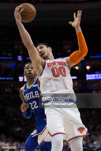Enes Kanter of the New York Knicks controls the ball against Richaun Holmes of the Philadelphia 76ers in the third quarter at the Wells Fargo Center...