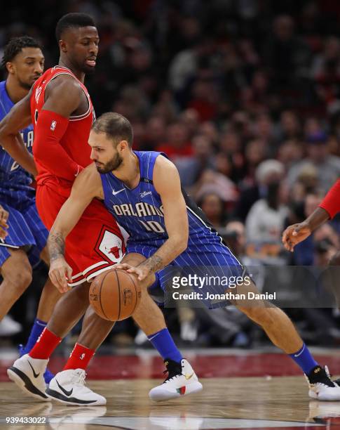 Evan Fournier of the Orlando Magic mves against David Nwaba of the Chicago Bulls at the United Center on February 12, 2018 in Chicago, Illinois. The...