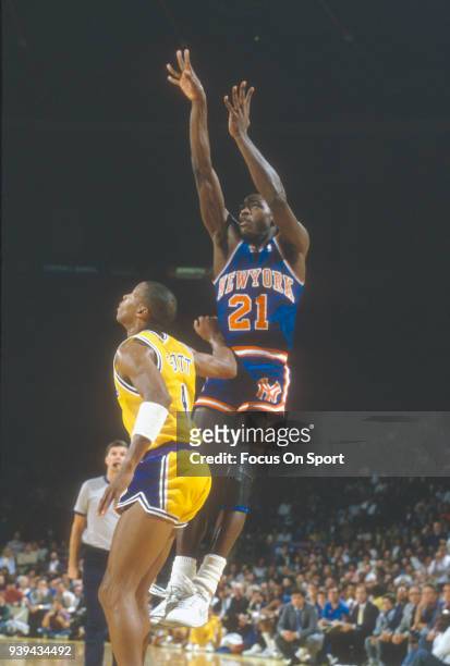 Gerald Wilkins of the New York Knicks shoots over Byron Scott of the Los Angeles Lakers during an NBA basketball game circa 1985 at The Forum in...