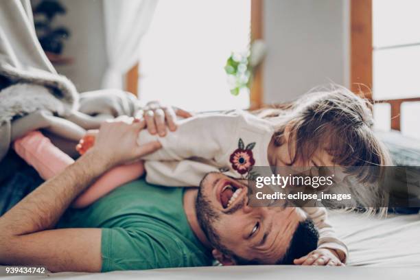 under the blanket - baby with parents imagens e fotografias de stock