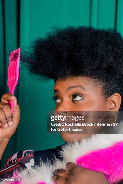 Beauty Portrait of Young Confident Woman with Afro Styling Her Hair with Pick