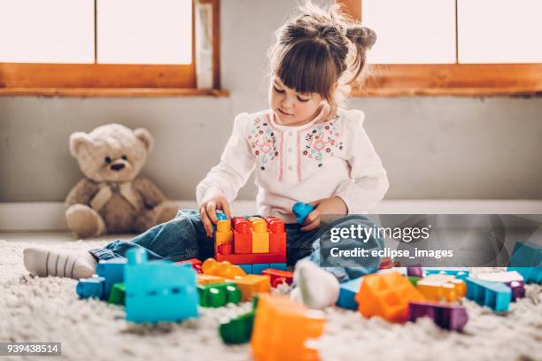 sweet child playing with plastic blocks - kids playing imagens e fotografias de stock